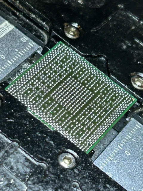 Chip lifted from the board with its solder ball array exposed