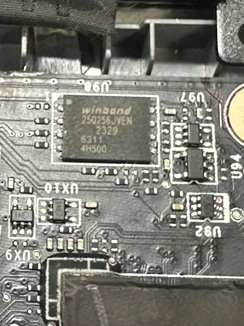 Memory chip soldered on a board, surrounded by tiny components