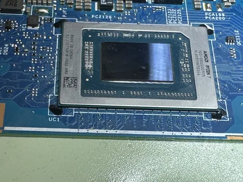 Die of an AMD Ryzen processor seen from above, on the board