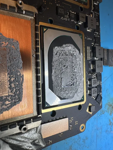 Cracked, dried-out thermal paste on a laptop processor