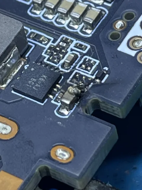 Integrated circuit on a blue board, next to its power components