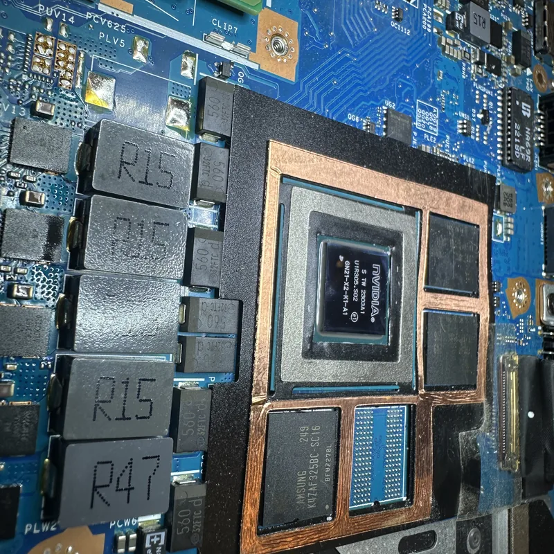 Close-up of a laptop board with the graphics processor and memory exposed
