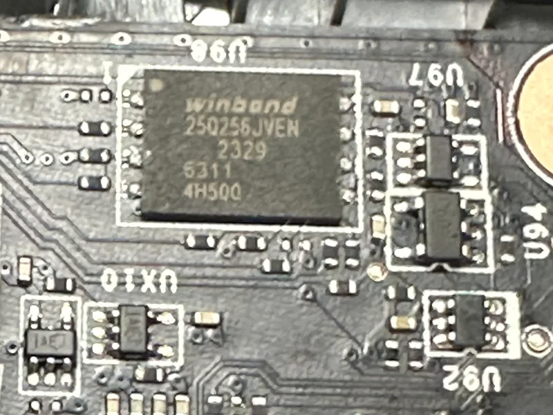 Memory chip soldered on a board, surrounded by tiny components