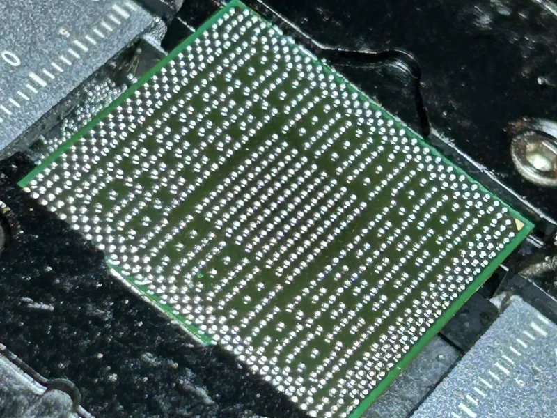Chip lifted from a board with its solder ball array exposed